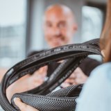 Blick über die Schulter einer Person, die einen oder mehrere Fahrradreifen in der Hand hält.