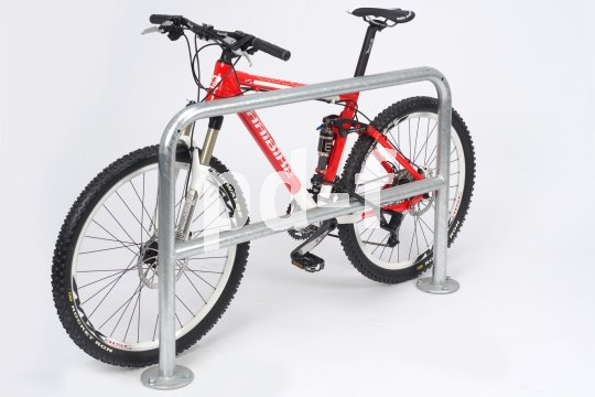 Ein Fahrrad lehnt an einem Anlehnbügel, der einem Stück Geländer ähnelt.