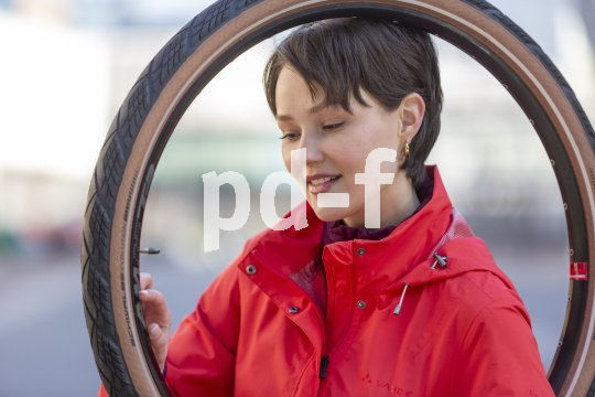 Frau hält Fahrradreifen