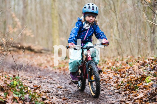 Kinder bereitet Mountainbiken im Wald bereits in jungen Jahren viel Freude. Kind fährt mit Mountainbike