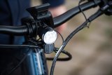 Ein am Lenker eines Fahrrades montierter Scheinwerfer mit Reflektor.
